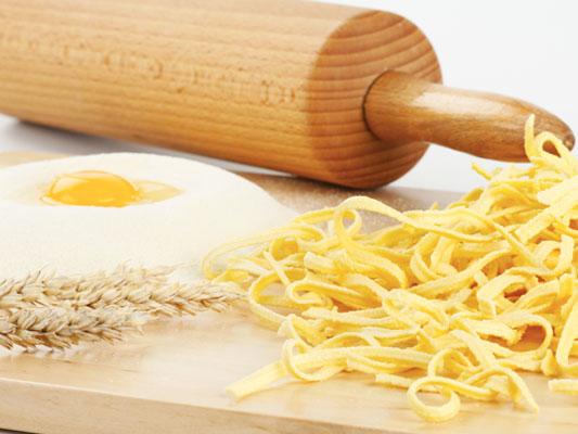 A freshly cracked egg with regional raw ingredients and traditional spaetzle